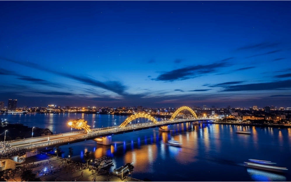 Tourists watch the Dragon Bridge fire show from cruise ships